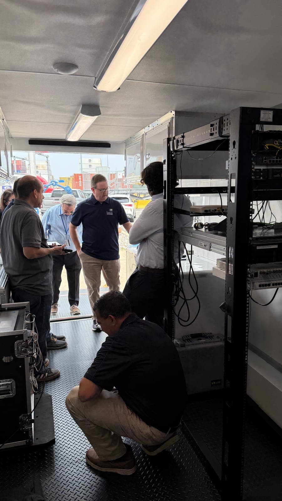 Future Technologies engineers walking customers through the live network rack inside the Lab on Wheels trailer